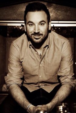 Monochromatic photo of a man smiling at camera